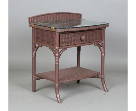 A modern Lloyd Loom mauve painted bowfront bedside table, height 71cm, width 61cm, depth 42cm.Buyer’s Premium 29.4% (includin