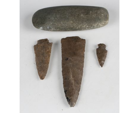 Two Native American chip carved stone arrow heads and a larger spear head, length 15cm, together with a polished stone axe he