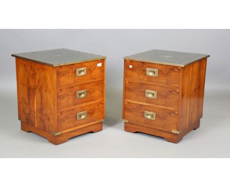 A pair of late 20th century yew campaign style bedside chests with brass-bound inset green leather tops, height 57cm, width 4