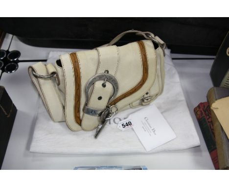A CREAM COLOURED SHOULDER BAG, with sleeve, maintenance leaflet and No.00921047