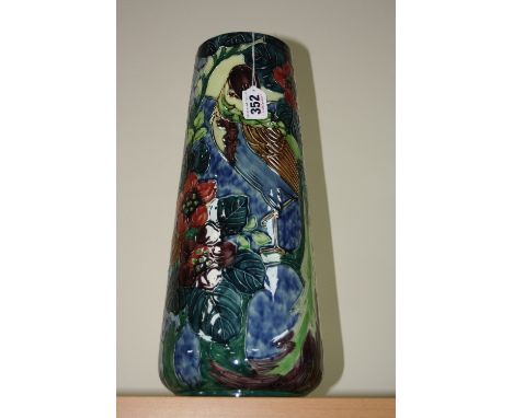 A THOMAS FORESTER & SONS TROGON WARE VASE, tube lined decorated with Parrot and trees on a blue ground, signed R. Dean, heigh