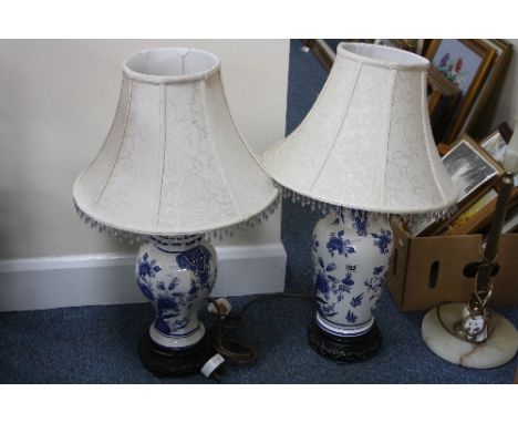 TWO BLUE AND WHITE POTTERY TABLE LAMPS, with ebonised bases and shades and an onyx standard lamp with shade (3)