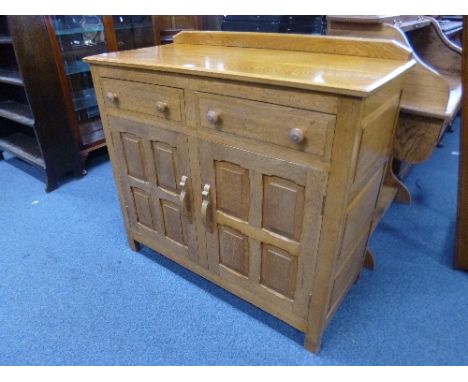 A LIGHT OAK SIDE CABINET WITH RAISED BACK, two drawers, panelled doors and sides, approximate size width 102cm x depth 46cm x