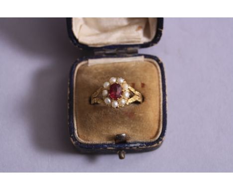 A YELLOW METAL RUBY AND SEED PEARL CLUSTER RING, ring size P1/2, boxed