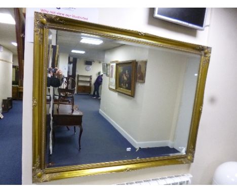 A LARGE GILT FRAMED WALL MIRROR, approxim ate size 137cm x 106cm