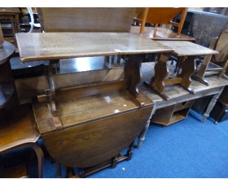 AN OAK STAINED COFFEE TABLE, a similar smaller table and a gate leg table (3)