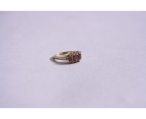 A 9CT THREE STONE RUBY AND DIAMOND CLUSTER RING, ring size R