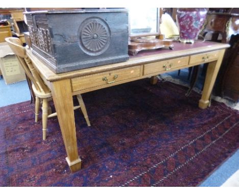 A LIGHT OAK LIBRARY TABLE, with six drawers and red leather studded inset top on square tapering supports with spade feet, ap