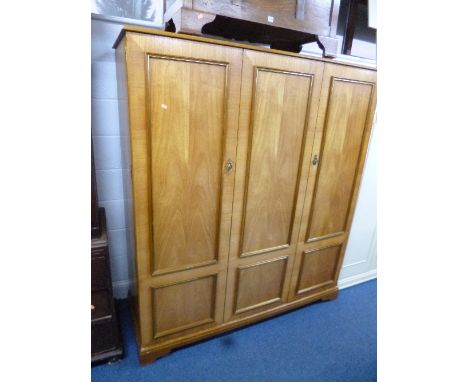 A FOUR PIECE MODERN BEDROOM SUITE, comprising of a three door wardrobe, dressing table with triple mirror, stool and a chest 