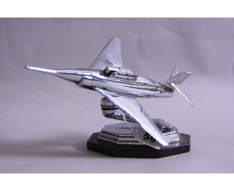 A CHROME TABLE LIGHTER IN THE FORM OF A FIGHTER JET PLANE, Regd number 869697. 869675. 880107/56