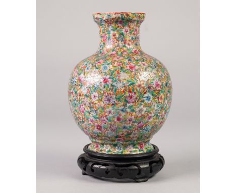 A CHINESE LATE QING DYNASTY PORCELAIN GLOBULAR VASE, painted autour in polychrome enamels with Millefleurs decoration, bearin