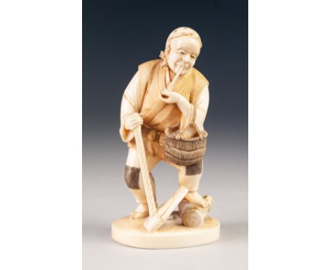 A GOOD JAPANESE MEIJI PERIOD ONE PIECE CARVED IVORY FIGURE of a peasant male, standing smoking a pipe, holding a basket over 