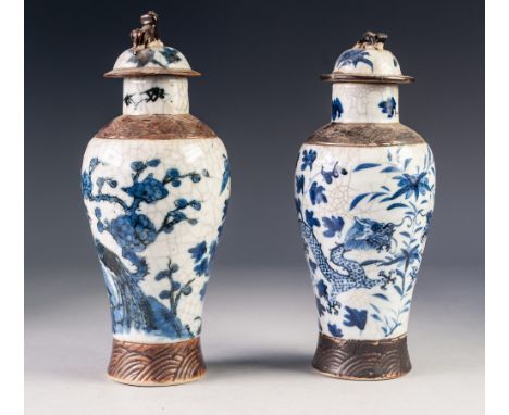 PAIR OF TWENTIETH CENTURY CHINESE CRACKLE GLAZED POTTERY VASES WITH COVERS, each of oviform with dog of fo finial to the dome