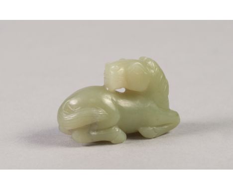 SMALL AGED CHINESE CELADON JADE MODEL OF A RECUMBENT HORSE 2" (5cm) long