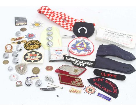 A collection of vintage fire brigade buttons, enamel badges and patches