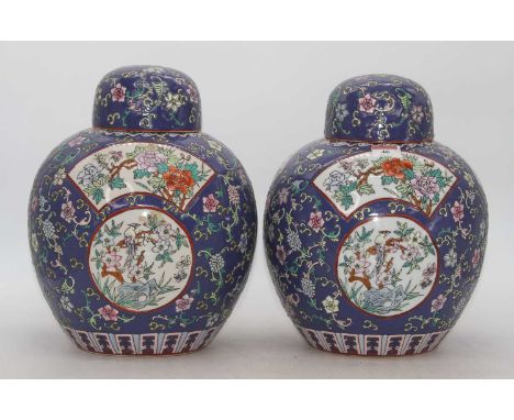 A pair of Chinese ginger jars and covers, each of globular form, enamel decorated with flowers, h.29cm 