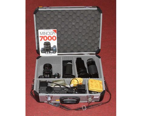 A Minolta 7000 SLR camera, cased with various accessories 
