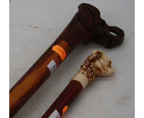 An African carved hardwood walking stick, the handle in the form of an elephant, 97cm; together with another with a handle in