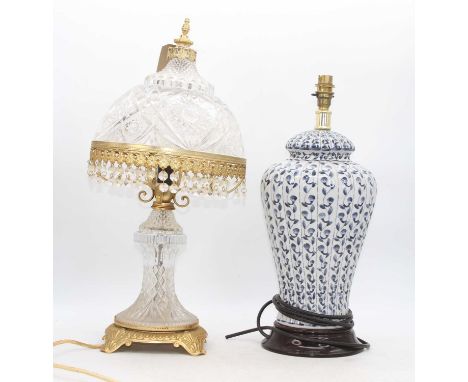 A 20th century pressed glass and brass mounted table lamp, h.53cm; together with a blue and white table lamp (2)