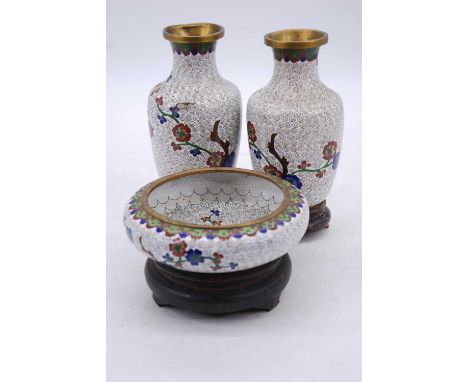 A pair of Chinese cloisonne enamel decorated vases and stands, h.19cm; together with a matching dish, dia.15cm 