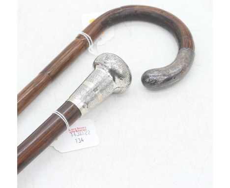 An early 20th century rosewood walking stick, having white metal handle, 92cm; together with a silver handled bamboo example,