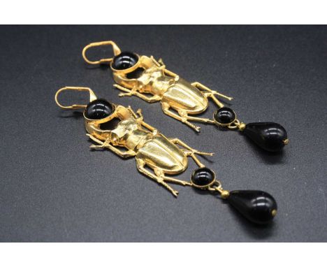 A pair of gilt metal and black enamel scarab beetle ear pendants, of good size, 10cm (including fittings)