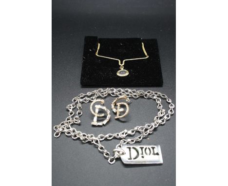 After Christian Dior - a metal necklace with pendant; together with a gilt metal necklet; and a pair of gilt metal and paste 