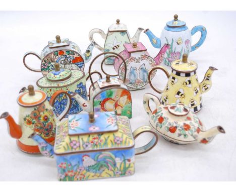 A collection of Eastern enamel decorated teapots, the largest h.9cm 