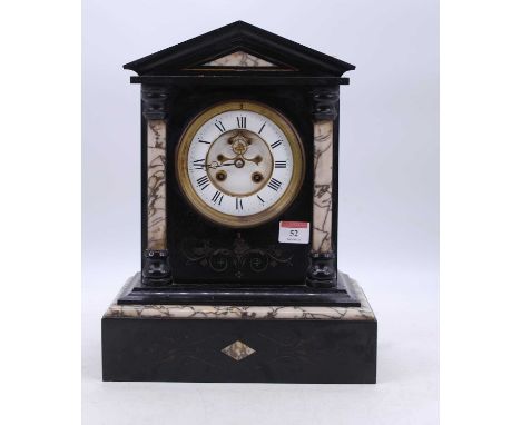 A Victorian black slate mantel clock, of architectural form, the enamelled chapter ring showing Roman numerals, having visibl