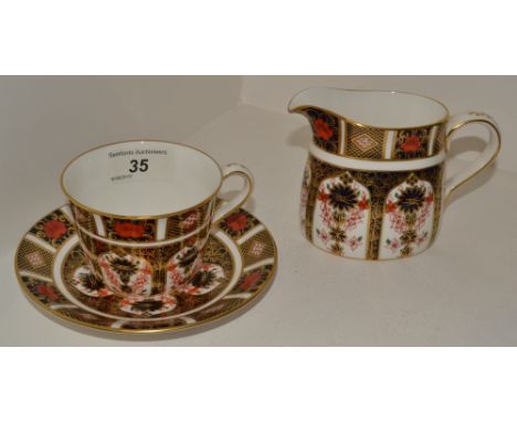 A Royal Crown Derby 1128 Imari milk jug, first quality;  a Royal Crown Derby 1128 Imari teacup and saucer, both first quality