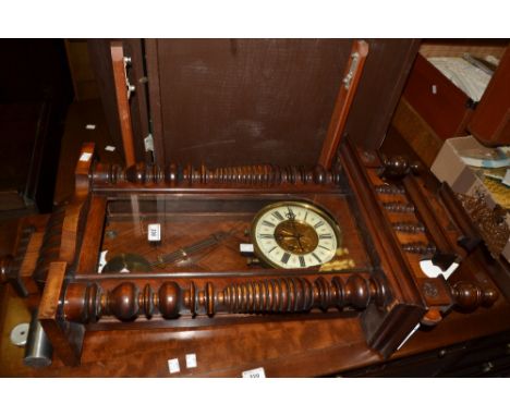 A late 19th century walnut Vienna wall clock, the white ivorine dial with Roman numerals, twin winding holes, architectural p