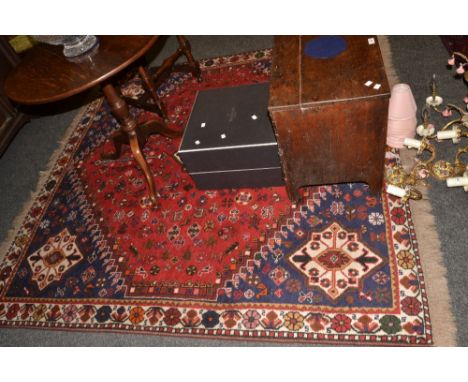 A Persian Qashqai  woollen carpet, with central red lozenge, within a blue ground, 197cm x 193cm