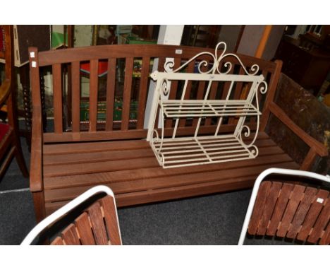 A teak garden bench; a circular garden table and four chairs