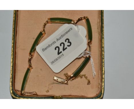 A Chinese gold coloured metal and green jade bracelet, stamped 14ct, cased
