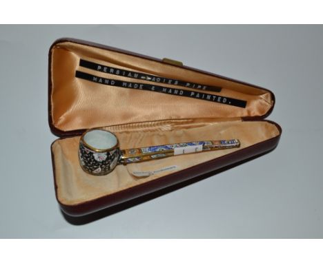 A 20th century Persian lady's pipe, enamelled in colours with stylised flowers and foliage