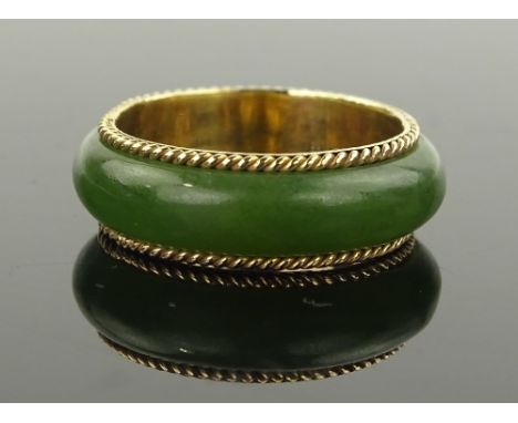 A 14 ct gold jade set band ring, band width 7 mm, size L