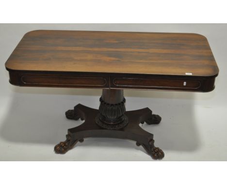 A William IV rosewood library table of rectangular form, 2 moulded frieze drawers raised on tulip carved centre column & plat