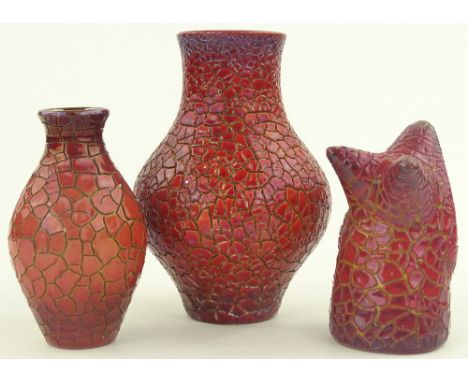 3 pieces of Zsolnay Pecs red crackle effect pottery, including a bulbous vase height 18.5 cm, vase on 3 feet height 13 cm and