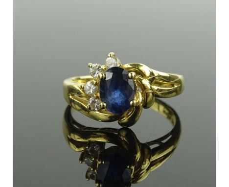 An 18 ct gold sapphire & diamond cluster ring, setting height 11 mm, size M