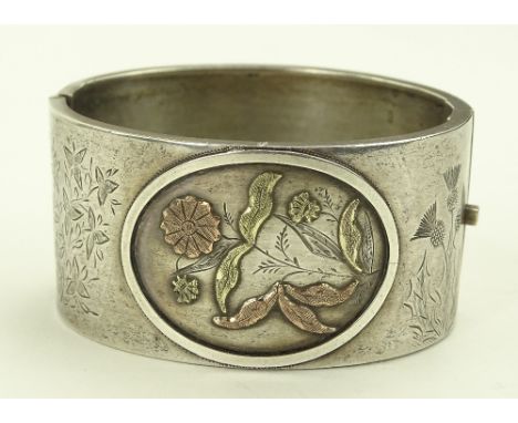 A Victorian gold inlaid silver hinged bangle