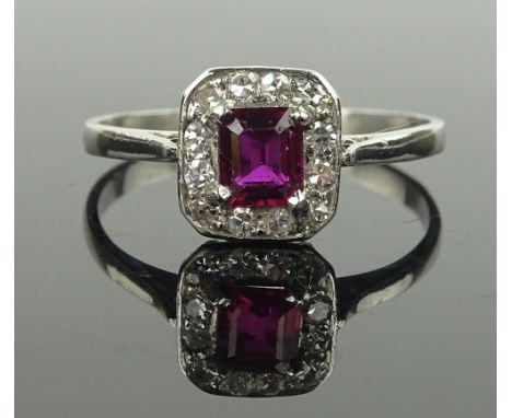 A platinum ruby & diamond cluster ring, setting height 10 mm, size T