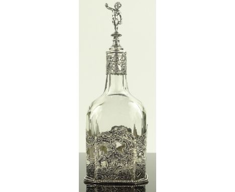 Continental glass decanter in relief cast silver stand, continental silver marks with cherub mounted stopper, height 21 cm
