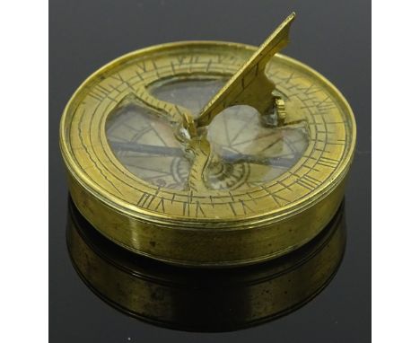 Miniature antique engraved brass pocket compass, inset glass panel with printed paper dial, diameter 4 cm
