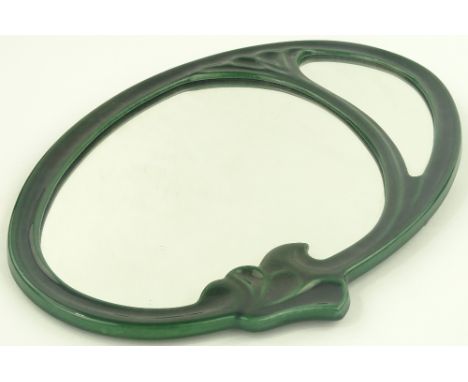 An Art Nouveau green enamel metal framed oval wall mirror, height 56 cm