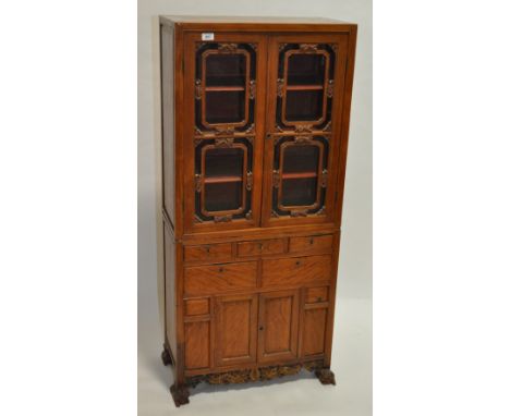 A Chinese early 20th century stained wood side cabinet of small size, carved lattice glazed cabinets above, drawers & cupboar