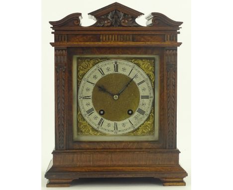 A Victorian carved walnut cased bracket clock, with carved shaped pediment, brass dial with silvered chapter ring and 8 day s