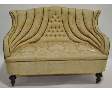A small Victorian upholstered parlour sofa on ebonised legs, width 1.3 m