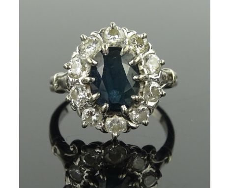 A large sapphire & diamond cluster ring, unmarked settings test as 18 ct white gold, setting height 16 mm, size M