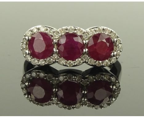 A 9 ct white gold ruby & diamond triple cluster ring, setting width 22 mm, size N