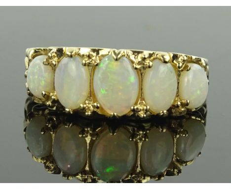 A 9 ct gold natural opal set half hoop ring, size P